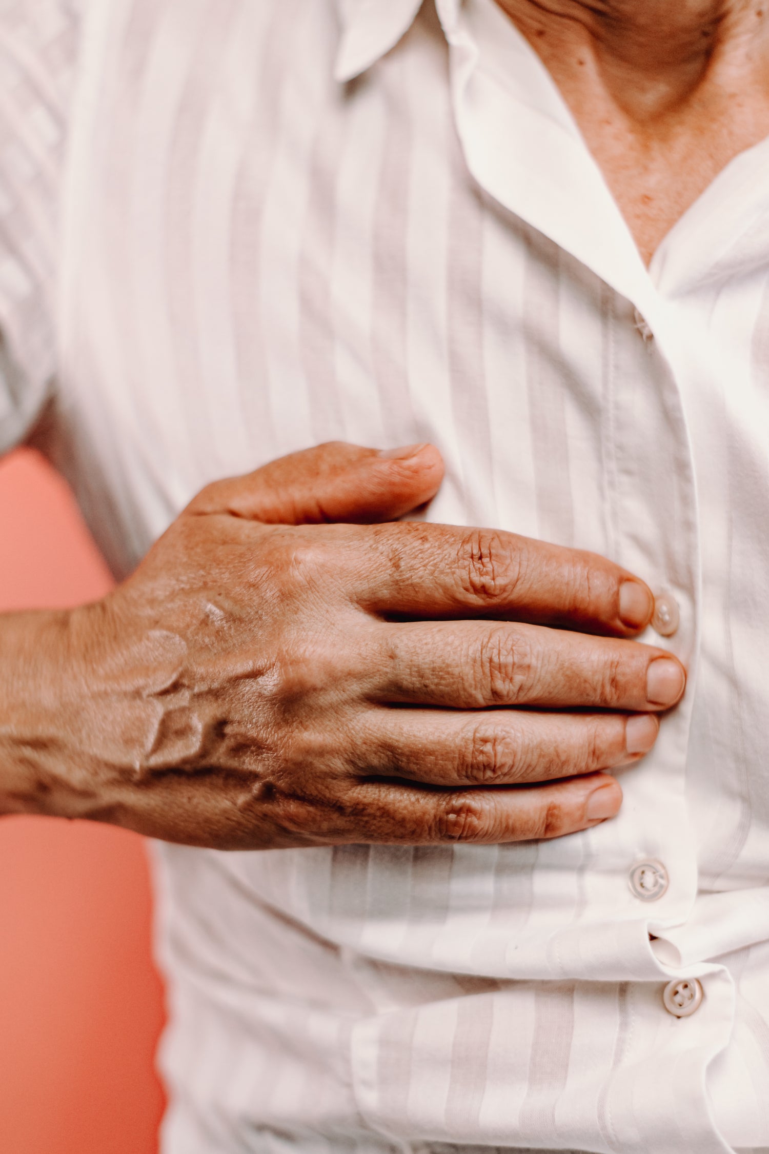 Man placing his hand on his chest